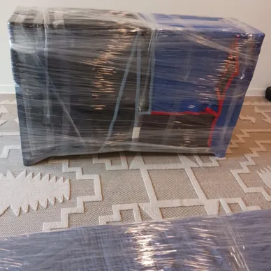 Professional packers carefully boxing household items